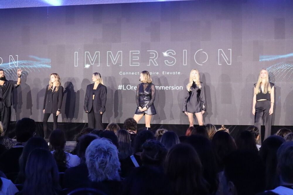 Brooke on stage in front of a full room