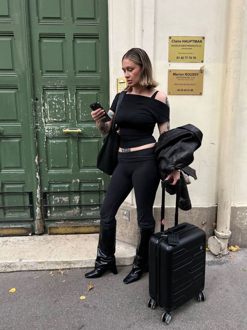 Brooke with her case outside a green Paris door