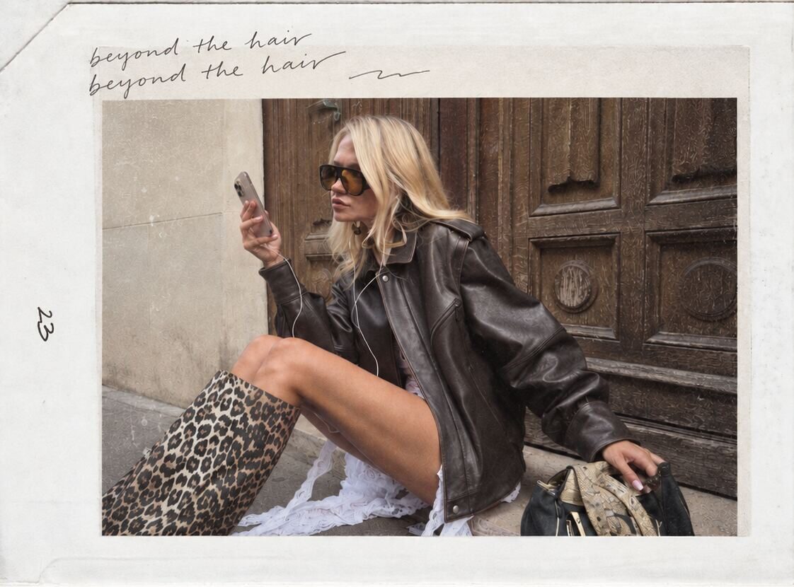 Brooke on a Paris doorstep filming on her phone, captioned beyond the hair